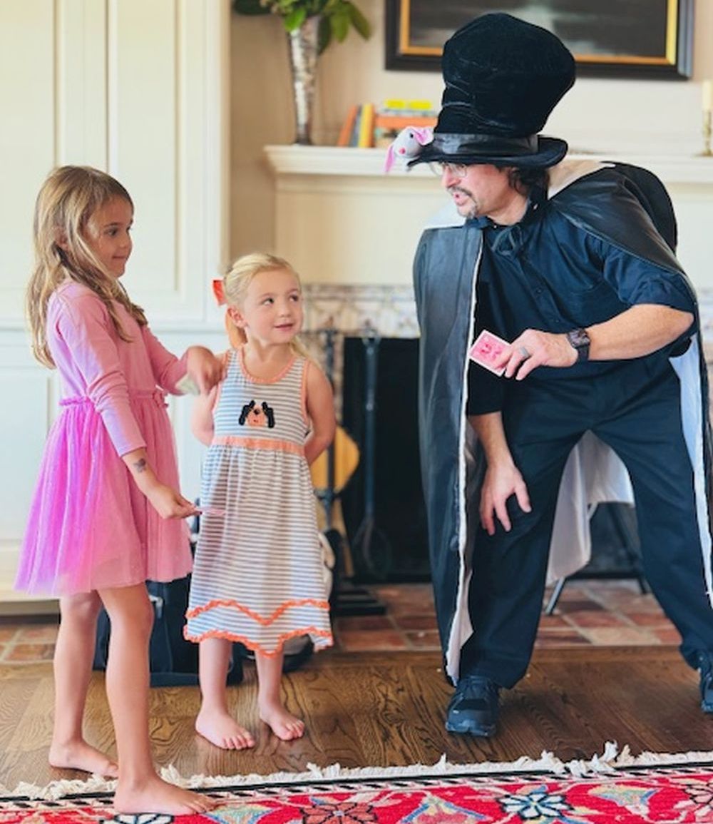 Two assistants helping with the magic during Wild Hare Magic performance.